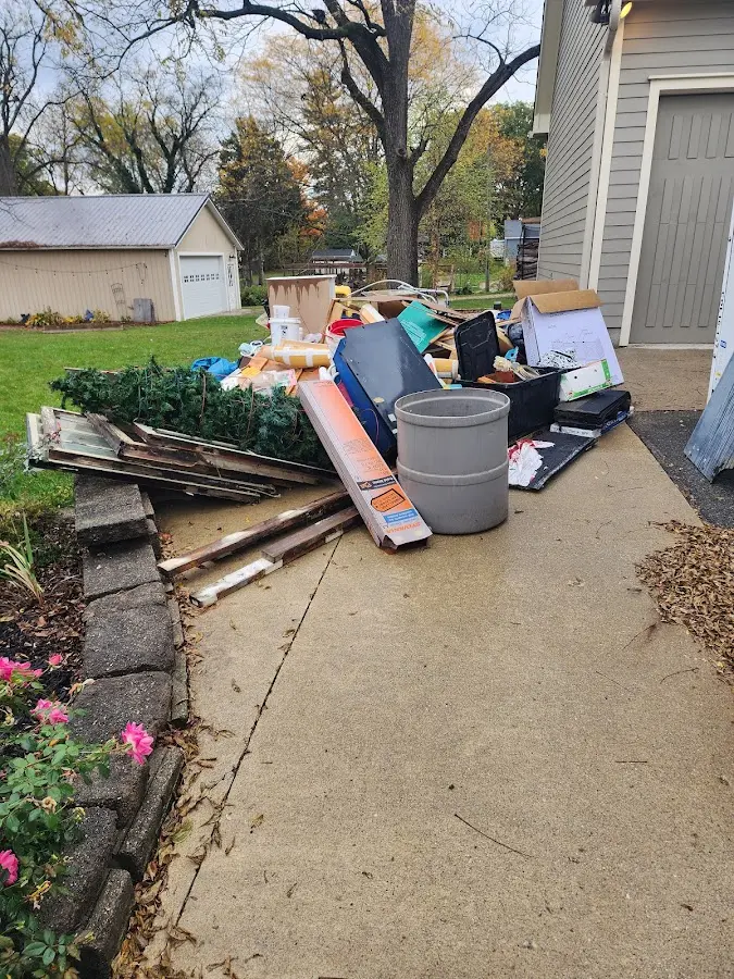 Dumpster being loaded with debris for Roofing Dumpster Rental in Corinth